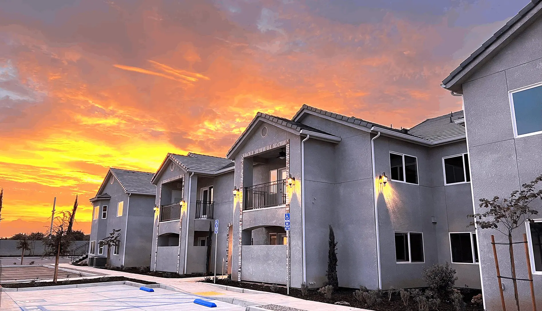 A row of houses with the sunset in the background.