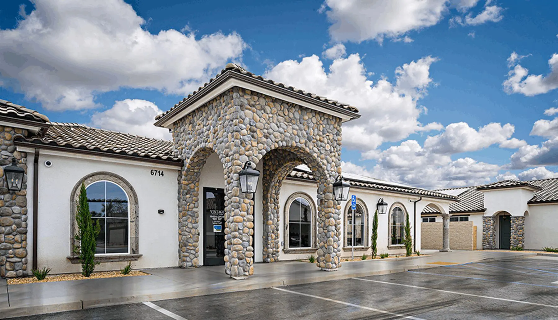 A building with arches and stone on the front.