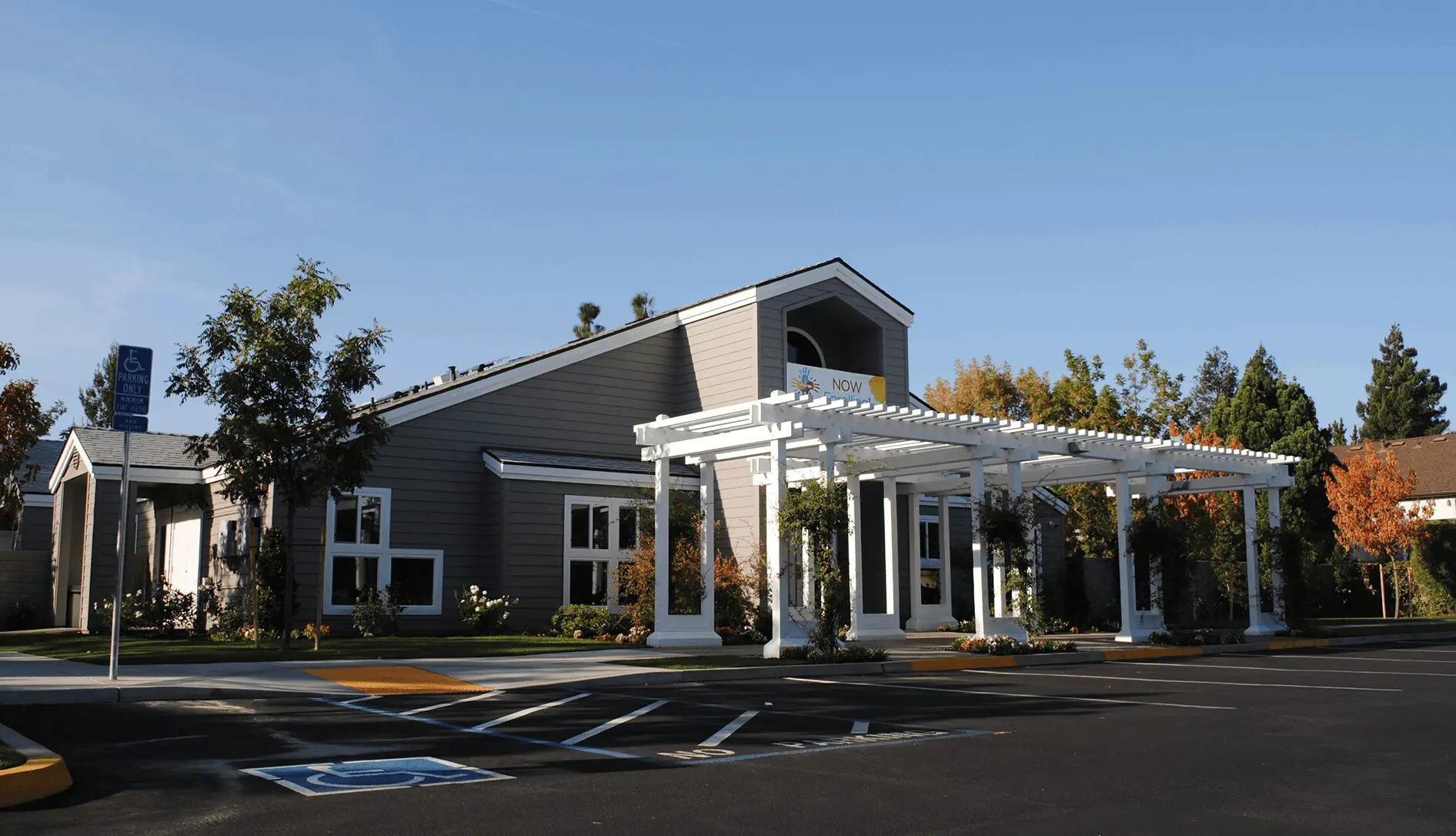 A large building with a white roof and columns.